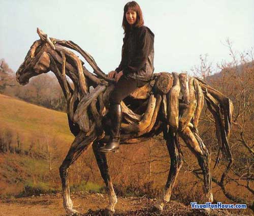 Heather on her wooden horse sculpture