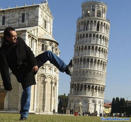 This man is Kicking over the leaning tower of pizza!