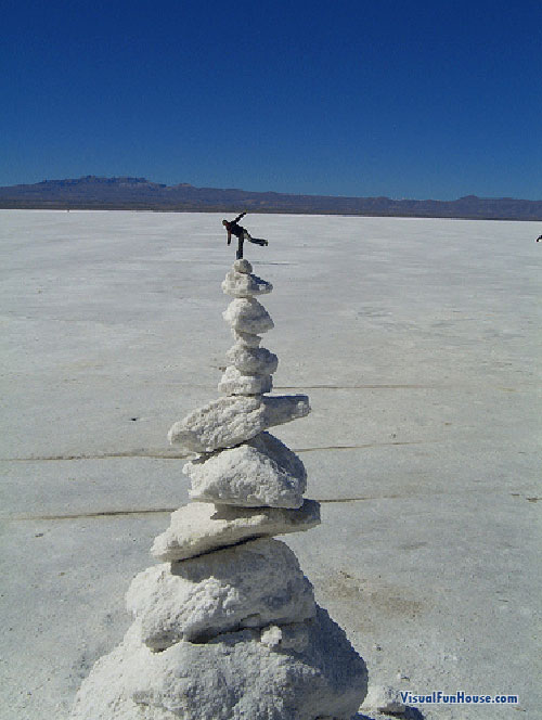 Miniature man on the rocks optical illusion